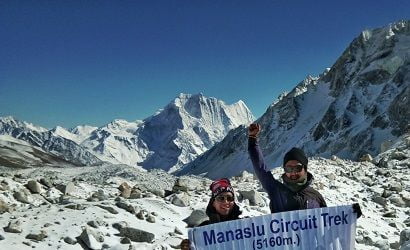 guide to manaslu circuit trek at top of larkey pass waving hand for picture