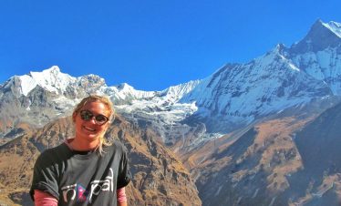 Happy girl smiling for camera on her Annapurna base camp trekking adventure in nepal