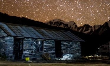 Stars and the moutain captured in the night with twinkling stars