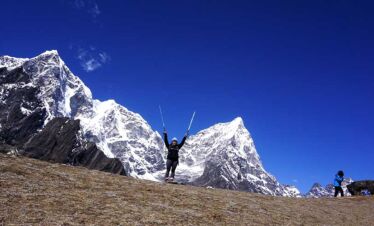 Happy trekker posing for picture with her walking poles
