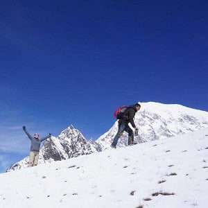 Trekker excited on the top of kyanjing ri on langtang valley circuit hike