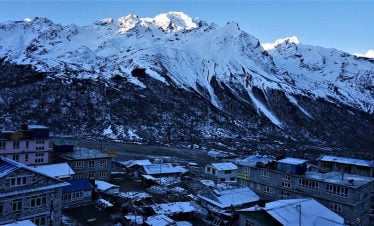 The last village of Ku\yanjing gompa with sun rising at the top of Nayakang peak