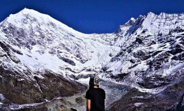Female solo trekker looking at the glacier of Langtang himalaya