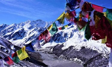 Looking through the opening of prayer flags in Langtang valley circuit trek