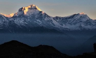 Tourist taking picture of sunrise from Khopra danda