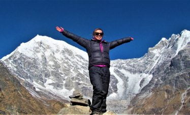 Girl smiling infront of Mt Langtang Liring and its glacier