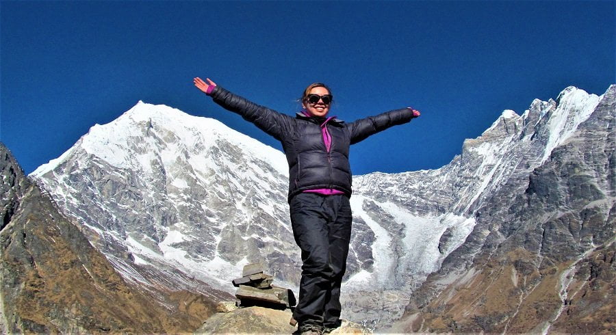 Girl smiling infront of Mt Langtang Liring and its glacier