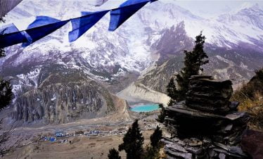 Manang village and Gangapurna lake seen in distance while trekking down from Nar phu valley over kang la pass