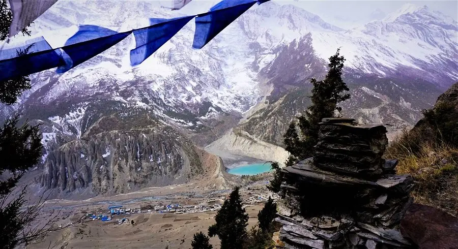 Manang village and Gangapurna lake seen in distance while trekking down from Nar phu valley over kang la pass