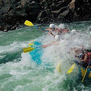 Folks enjoying the river water splashing during rafting trip in nepal