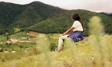 Close snap of Champadevi hill and a girl looking at the summit