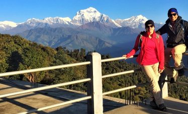 Couple at Ghorepani village with smile in front of the Mt Dhaulagiri