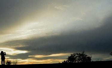 Girl taking picture of sunset in Zenith