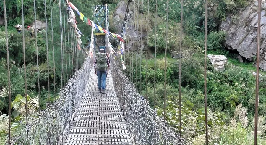 Starting Langtang circuit trek after crossing the bridge filled with prayer flags