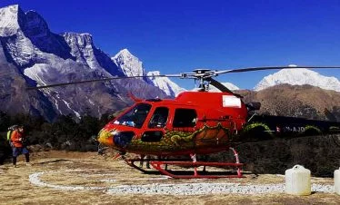 Helicopter lading infront of Everest Himalaya range while passenger are taking their breakfast