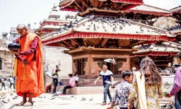 monk paying his respect to sun at patan