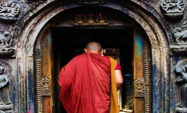 Monk entering Golden Bihar - captured in our patan day tour