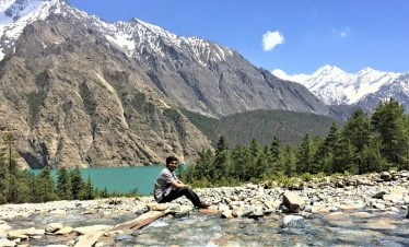 Smiling infront of Poksundo lake and the snow capped Himalaya.