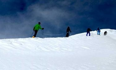 Climbers connected with rope on the way up to the summit of Tharpu chuli peak