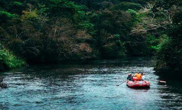Rafting in the nature and river with white water across the greenery