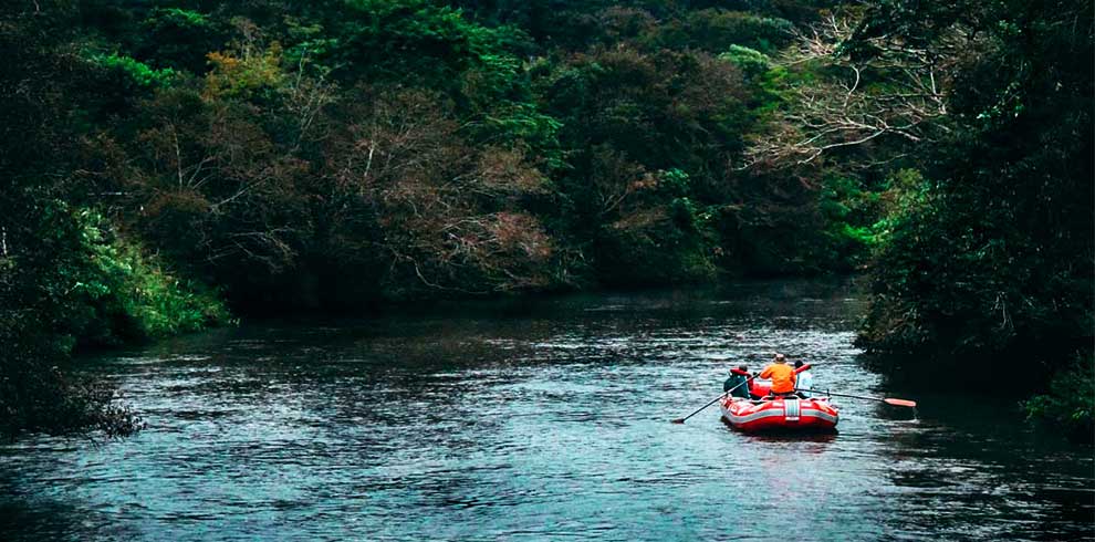 Rafting in the nature and river with white water across the greenery