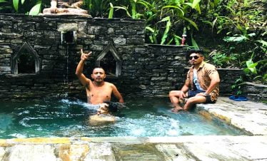 Boys enjoying the pool water after river rafting as an adventure.