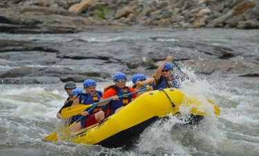 Group of Nepalgram clients paddling in Trishuli river as a part of their river rafting trip extension in Nepal holiday