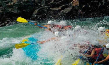 Clients of Nepalgram enjoying the splash of water while rafting in trishuli riverq