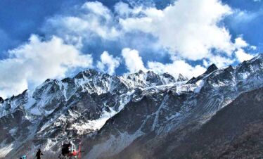 helicopter infront of mountain range of Langtang