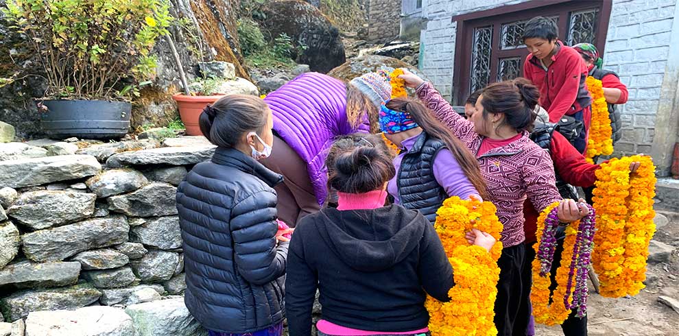 During the local festival of Hindu - Buddhist women buying garlands for their house decoration at Phakding