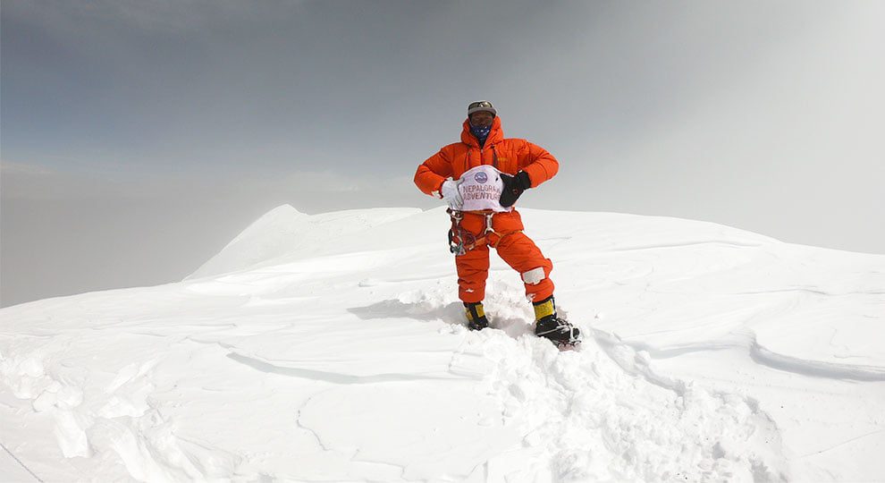 Climbing guide with flag of Nepalgram at the summit