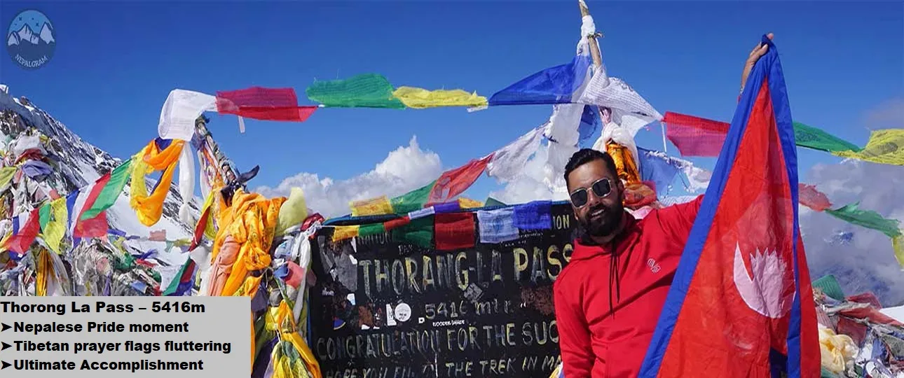 A moment of pride and peace at thorong la pass with the nepal flag and prayer flags.